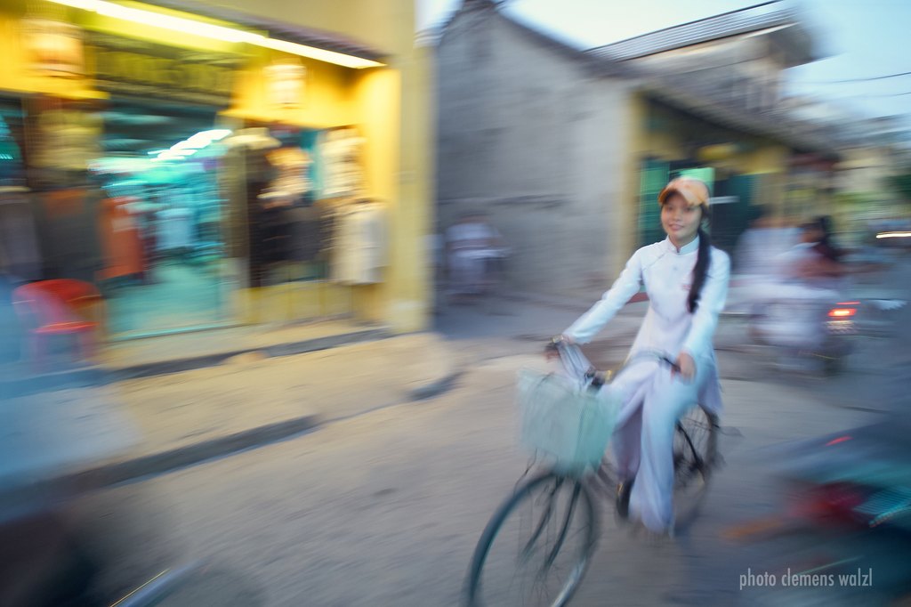 Radfahrerin im weißen Áo dài, Bewegungsunschärfe, Vietnam